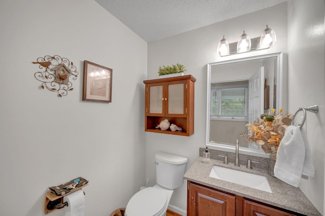 1216 Winding Dr, Sevierville, TN 37876 - half bathroom featuring toilet, vanity, and a textured ceiling