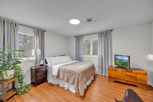 1216 Winding Dr, Sevierville, TN 37876 - bedroom with light wood finished floors, a textured ceiling, and baseboards
