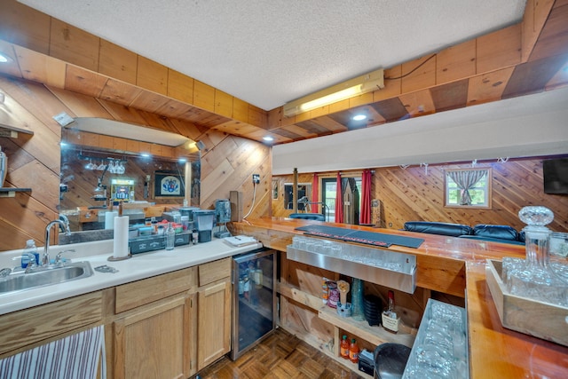 1216 Winding Dr, Sevierville, TN 37876 - indoor wet bar featuring wine cooler, wooden walls, and a textured ceiling