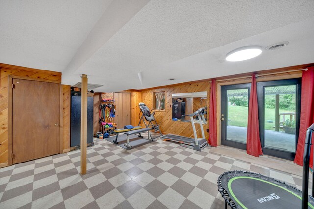 1216 Winding Dr, Sevierville, TN 37876 - workout room featuring tile patterned floors, wood walls, and a textured ceiling