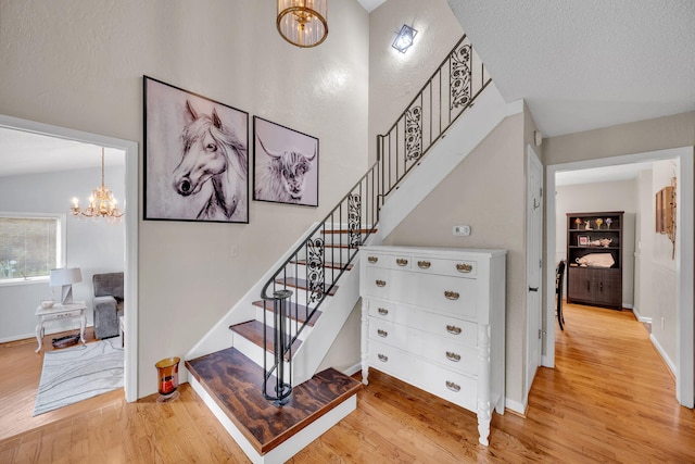 1216 Winding Dr, Sevierville, TN 37876 - staircase with a chandelier, wood finished floors, and baseboards