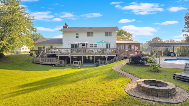 1216 Winding Dr, Sevierville, TN 37876 - rear view of house with stairway, a wooden deck, an outdoor fire pit, a yard, and an outdoor pool