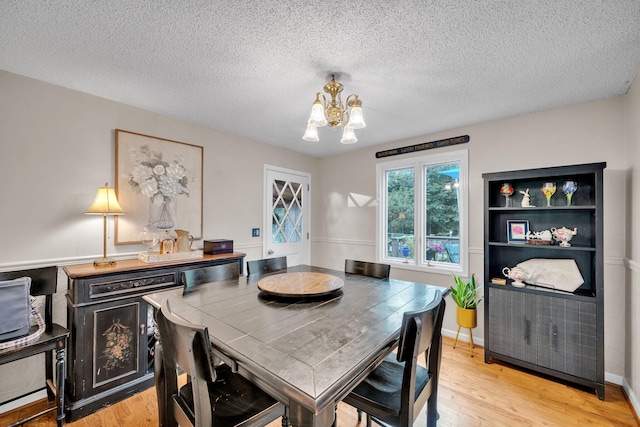 1216 Winding Dr, Sevierville, TN 37876 - dining space featuring a chandelier, light wood finished floors, and a textured ceiling