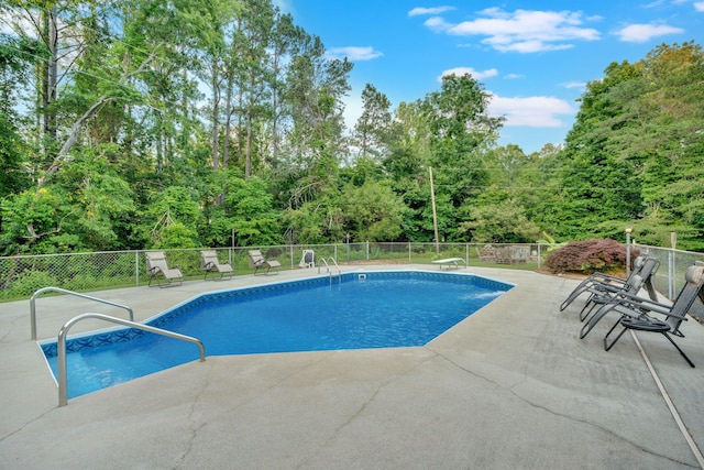 1216 Winding Dr, Sevierville, TN 37876 - view of pool with a patio and a forest view