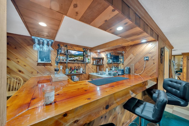 1216 Winding Dr, Sevierville, TN 37876 - indoor wet bar with wooden walls and a textured ceiling