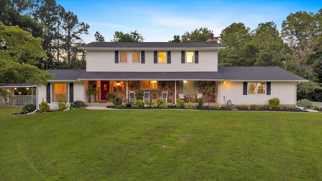 1216 Winding Dr, Sevierville, TN 37876 - view of front of property with a chimney, a porch, a front lawn, and stone siding