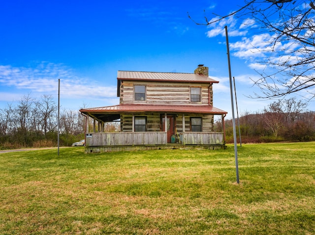 log cabin with a front yard and covered porch