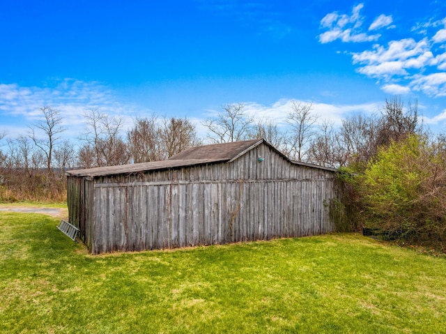 view of outbuilding featuring a yard