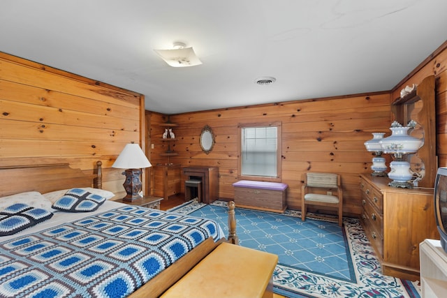 bedroom featuring wood walls