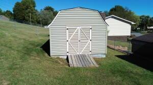 view of outbuilding with a yard