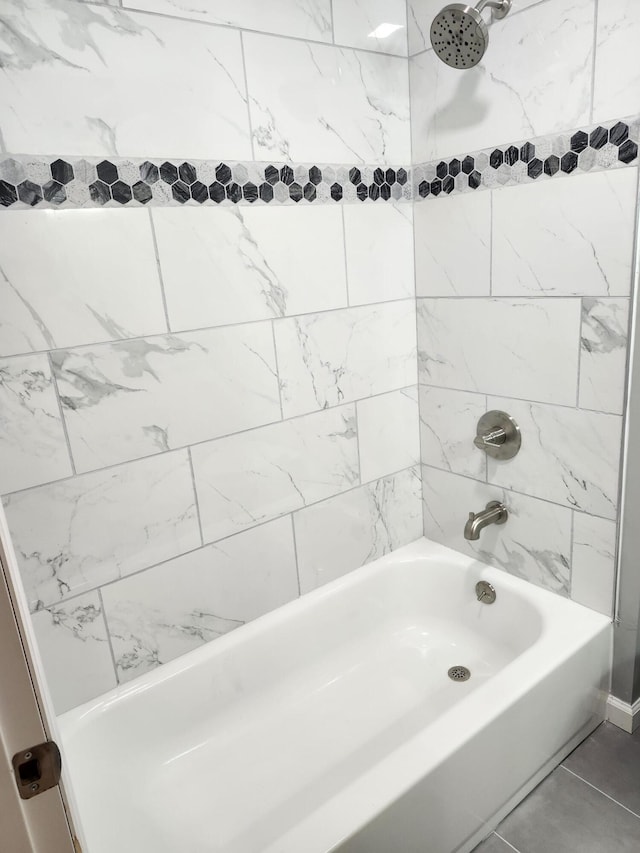 bathroom with tile patterned flooring and tiled shower / bath combo