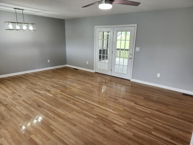 unfurnished room featuring hardwood / wood-style floors, french doors, and ceiling fan