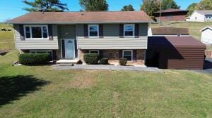 raised ranch featuring a front lawn