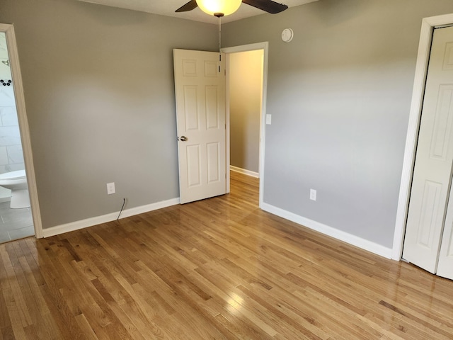 unfurnished bedroom with connected bathroom, ceiling fan, and light wood-type flooring