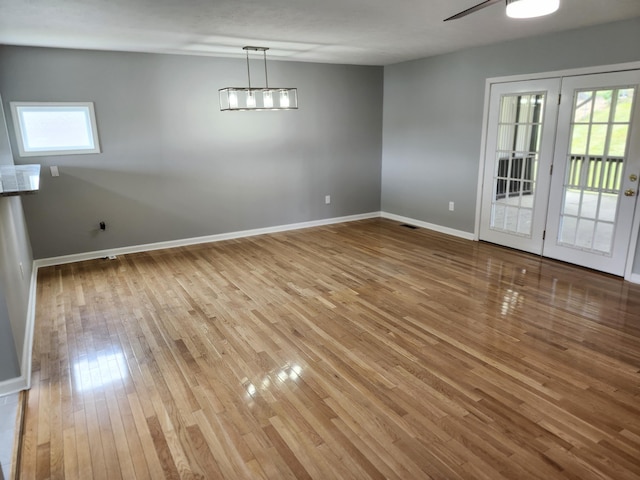 unfurnished dining area with light hardwood / wood-style floors and ceiling fan