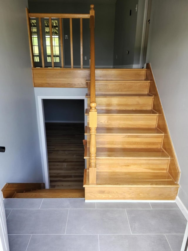 stairs featuring tile patterned flooring