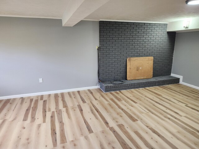 interior space with beam ceiling and light hardwood / wood-style flooring