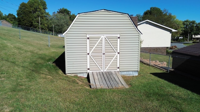 view of outdoor structure featuring a lawn