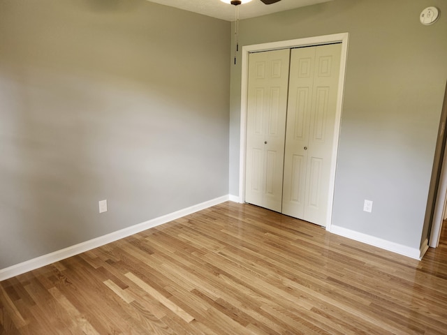 unfurnished bedroom featuring light hardwood / wood-style floors and a closet