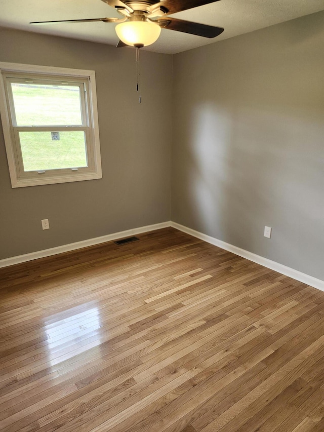 unfurnished room featuring ceiling fan and light wood-type flooring