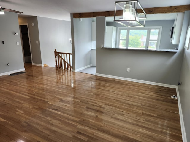 unfurnished room with ceiling fan and dark hardwood / wood-style flooring