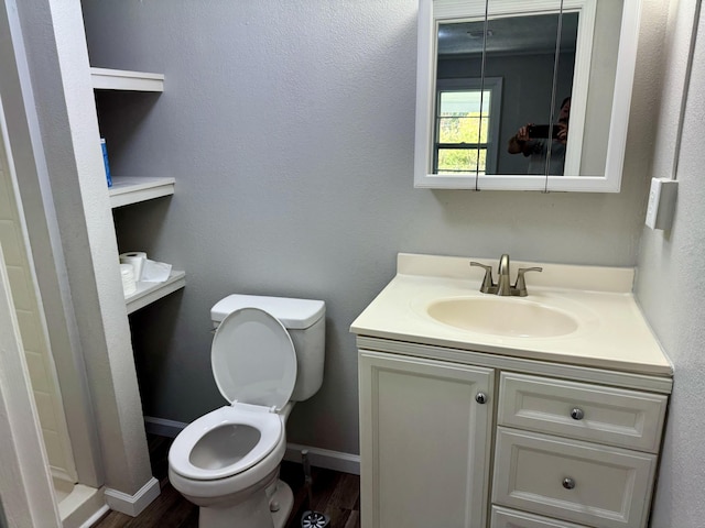 bathroom with vanity, toilet, wood-type flooring, and walk in shower