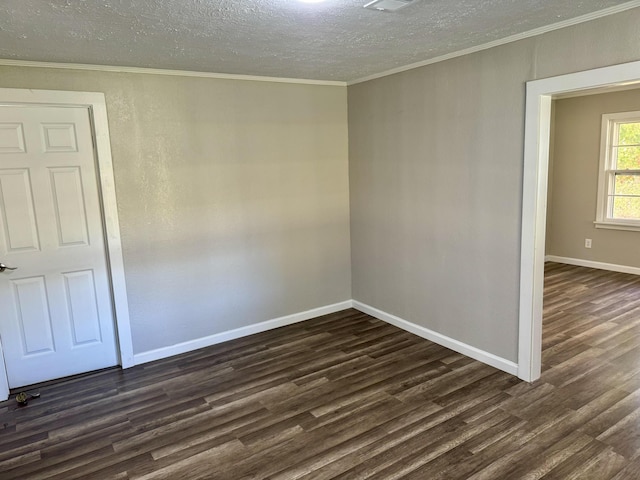 unfurnished room featuring a textured ceiling, ornamental molding, and dark wood-type flooring