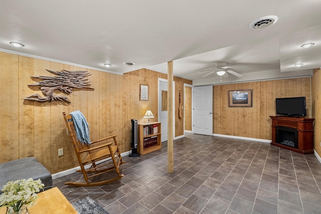 1116 Patterson St, Dandridge, TN 37725 - living area with wooden walls, a ceiling fan, and a fireplace
