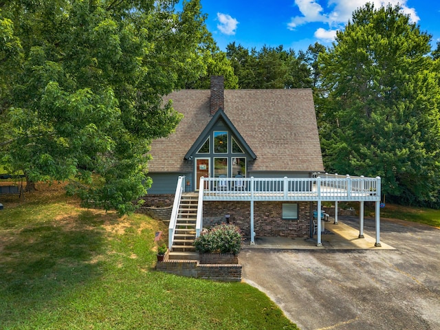 1116 Patterson St, Dandridge, TN 37725 - a-frame style home with a deck, a front lawn, asphalt driveway, stairs, and a shingled roof