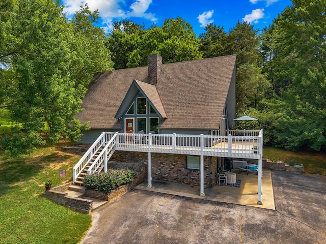 1116 Patterson St, Dandridge, TN 37725 - a-frame style home featuring a patio, a wooden deck, a shingled roof, stairway, and a front lawn