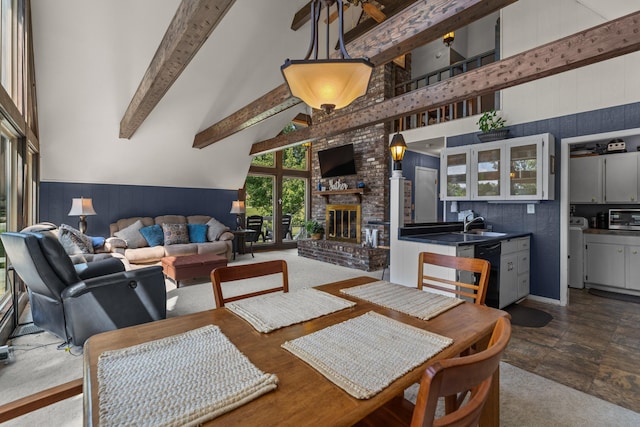 1116 Patterson St, Dandridge, TN 37725 - dining room with separate washer and dryer, high vaulted ceiling, beam ceiling, a fireplace, and wood walls