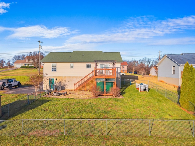 rear view of house with a lawn and a deck