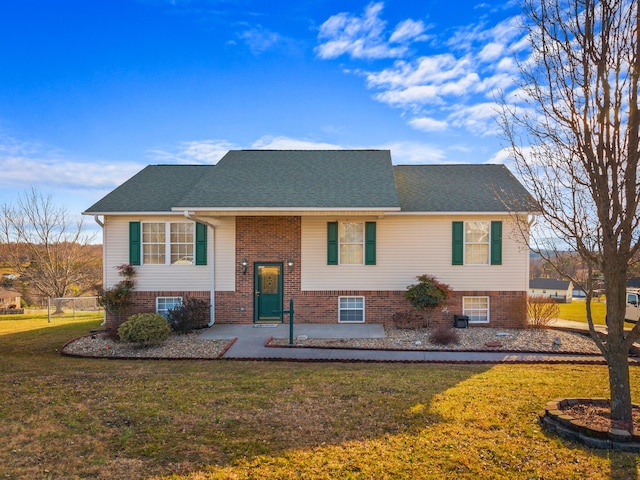 split foyer home with a front lawn