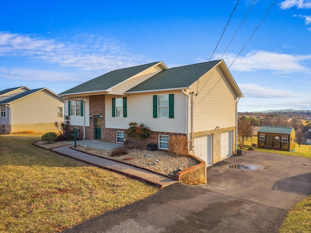 view of front of property with a garage and a front yard