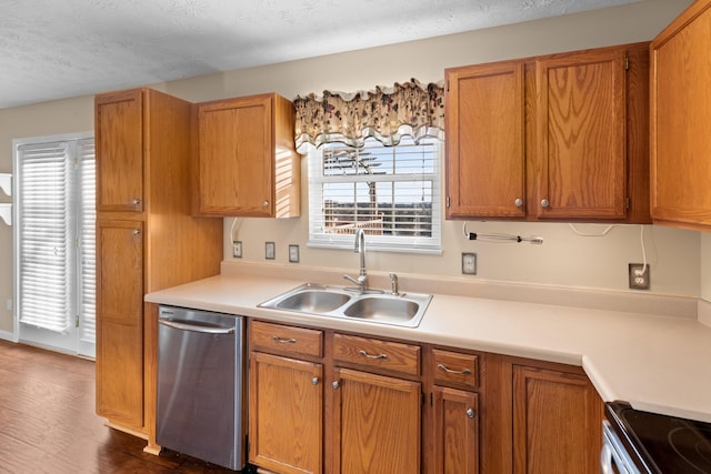 kitchen featuring dark hardwood / wood-style flooring, sink, stainless steel appliances, and a textured ceiling