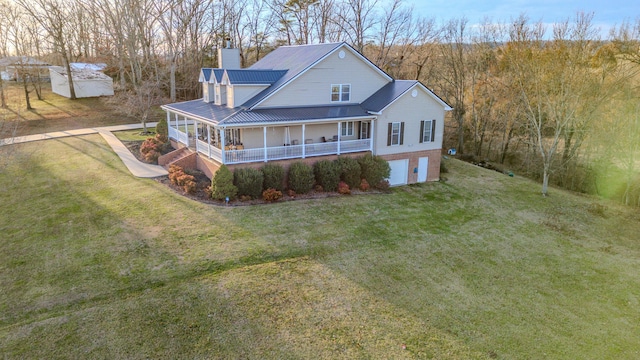 view of front facade with a garage, covered porch, and a front yard