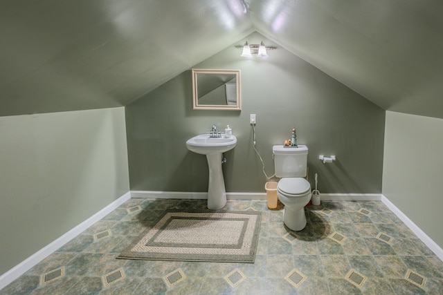 bathroom featuring lofted ceiling, sink, and toilet