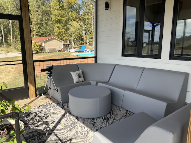 sunroom / solarium featuring view of wooded area