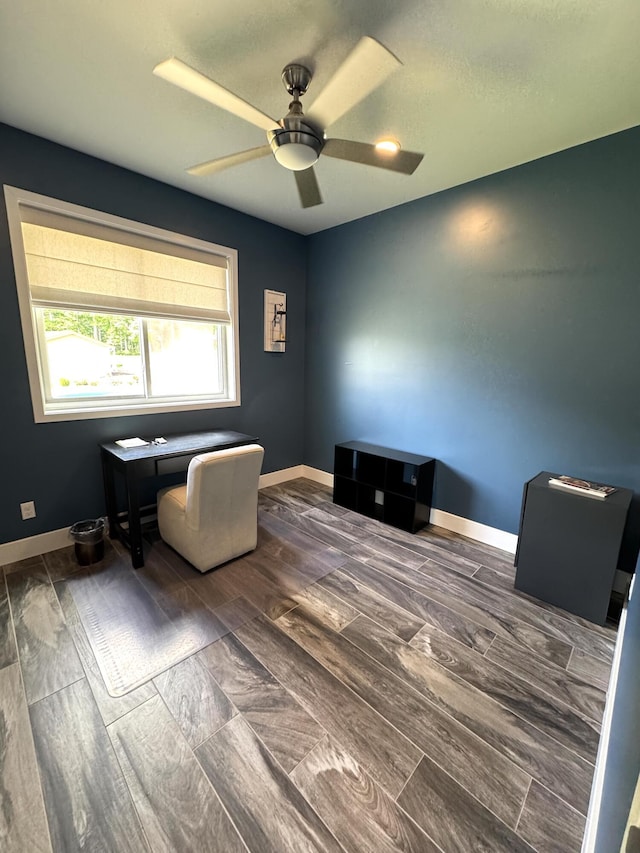 office with a ceiling fan, baseboards, and dark wood finished floors