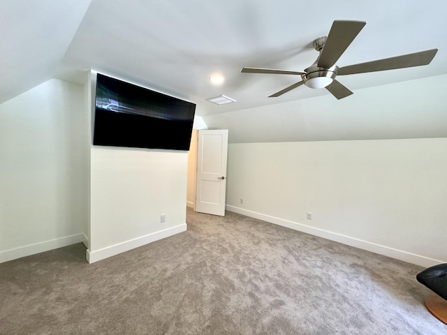 additional living space with vaulted ceiling, a ceiling fan, baseboards, and carpet flooring