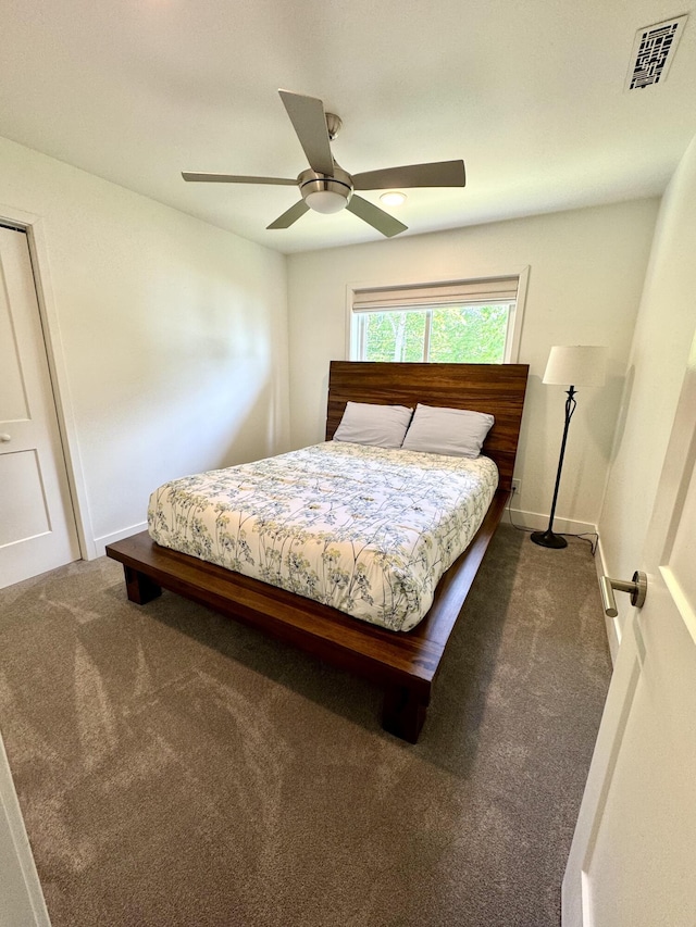 carpeted bedroom featuring ceiling fan and baseboards
