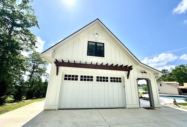 detached garage with an outdoor pool