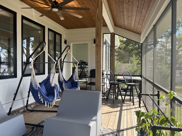 sunroom / solarium with a ceiling fan