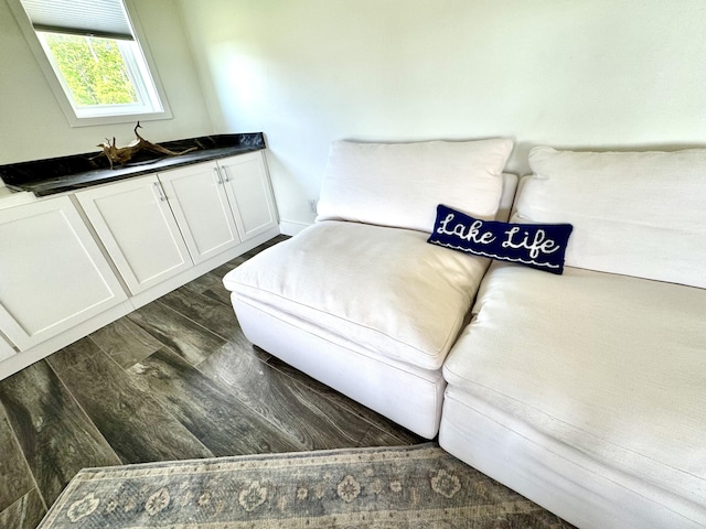 sitting room with dark wood-type flooring