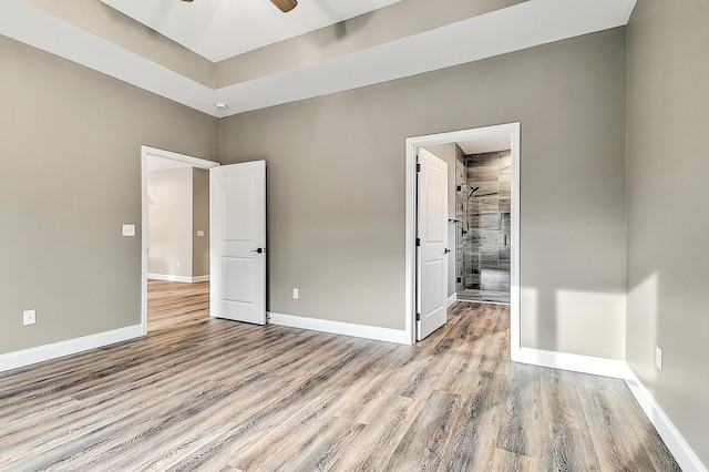 518 Deborahs Way, Greeneville, TN 37743 - unfurnished bedroom featuring wood finished floors, baseboards, and a walk in closet