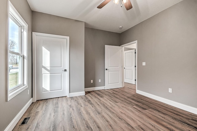 518 Deborahs Way, Greeneville, TN 37743 - unfurnished bedroom featuring wood finished floors, baseboards, and a ceiling fan
