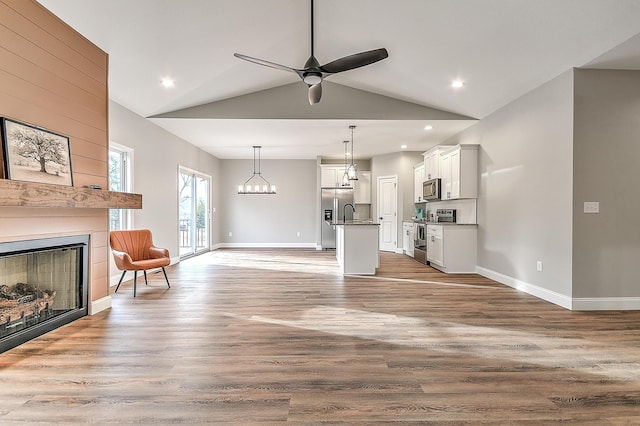 518 Deborahs Way, Greeneville, TN 37743 - living area with a fireplace, a ceiling fan, wood finished floors, baseboards, and lofted ceiling