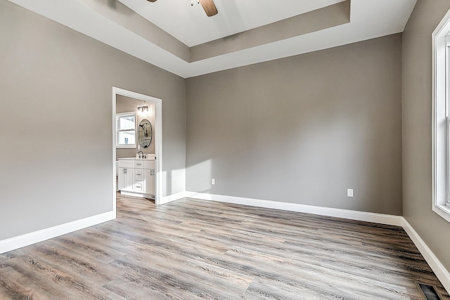 518 Deborahs Way, Greeneville, TN 37743 - unfurnished room featuring a ceiling fan, a raised ceiling, wood finished floors, baseboards, and a sink