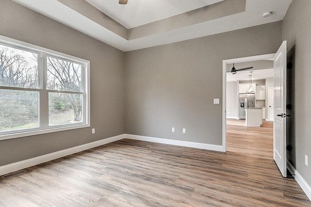 518 Deborahs Way, Greeneville, TN 37743 - empty room with ceiling fan, light wood-type flooring, baseboards, and a raised ceiling