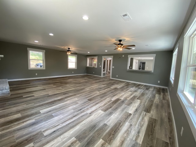 unfurnished living room with hardwood / wood-style flooring and ceiling fan